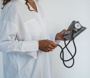 Woman Holding a Blood Pressure Monitor